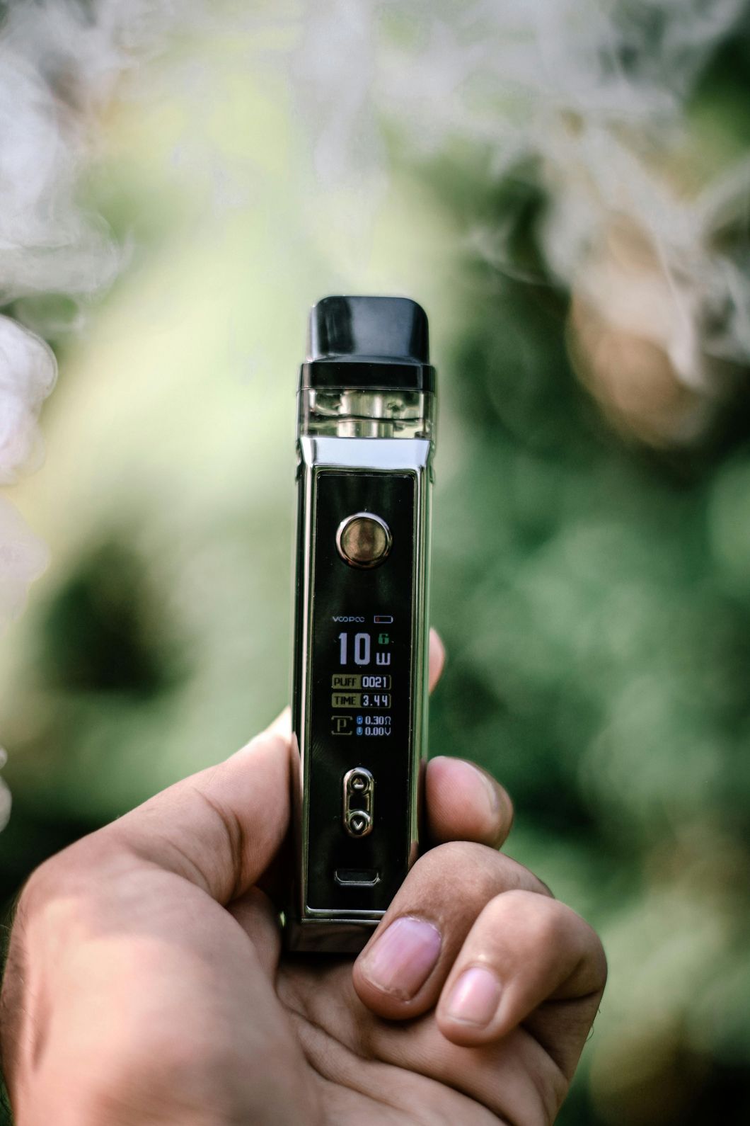 Person holding Delta 8 vape pen with colorful packaging, available at a Tulsa Delta 8 shop.