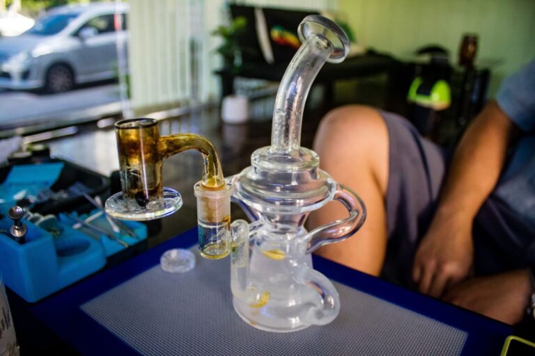 Glass bongs and colorful pipes displayed on shelves at a Tulsa head shop.