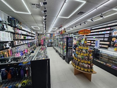 Well-lit Tulsa tobacco shop interior with shelves of products and a display of cigars and accessories.