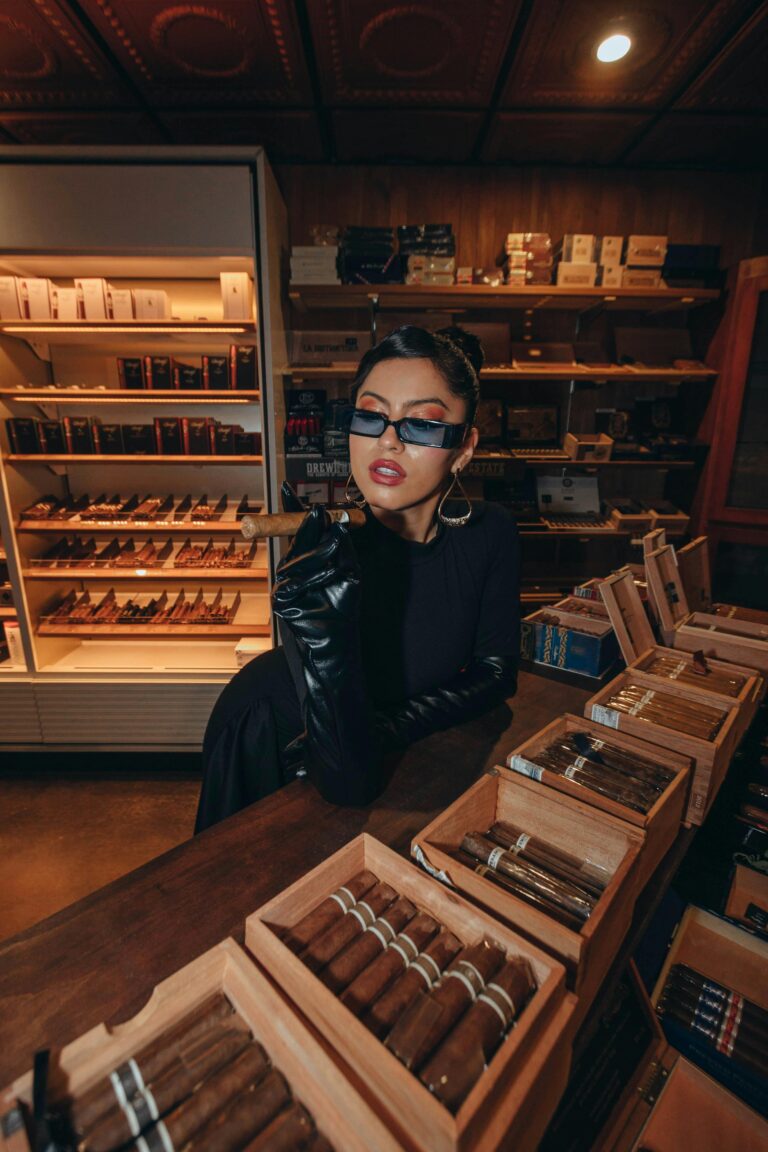 Stylish woman at counter with cigar boxes, shopping for budget & premium selections at Cigar Store Tulsa.