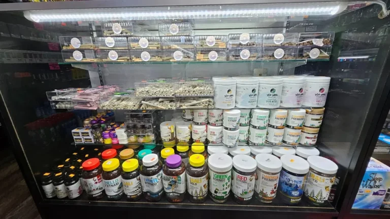 Retail display of various strains of labeled kratom products in jars at a well-stocked Store Tulsa.