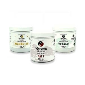 Close-up of red, white, and green vein kratom powder with leaves at a trusted Kratom Store Tulsa.