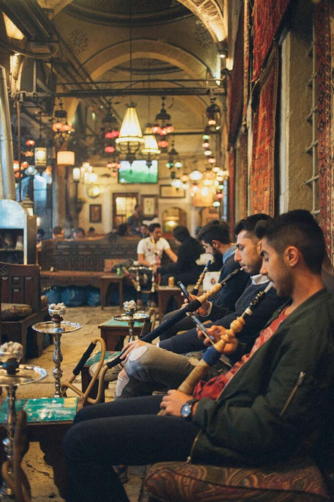 Visual guide of lounge etiquette with patrons relaxing; the essential rules for any Shisha Store in Tulsa.