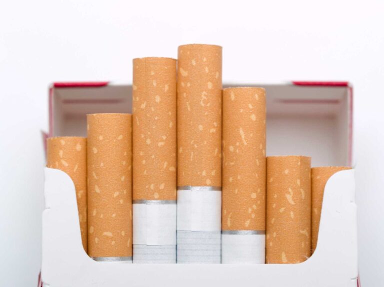 Close up of an open cigarette pack with tan filters, ready for sale at a top Cigarette Shop Tulsa.