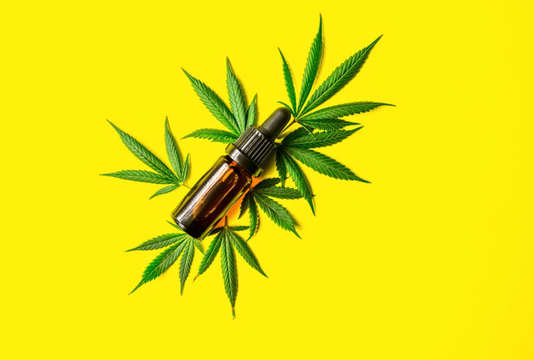 Display of a vibrant yellow full-spectrum CBD oil bottle with a dropper from a trusted cbd store tulsa.