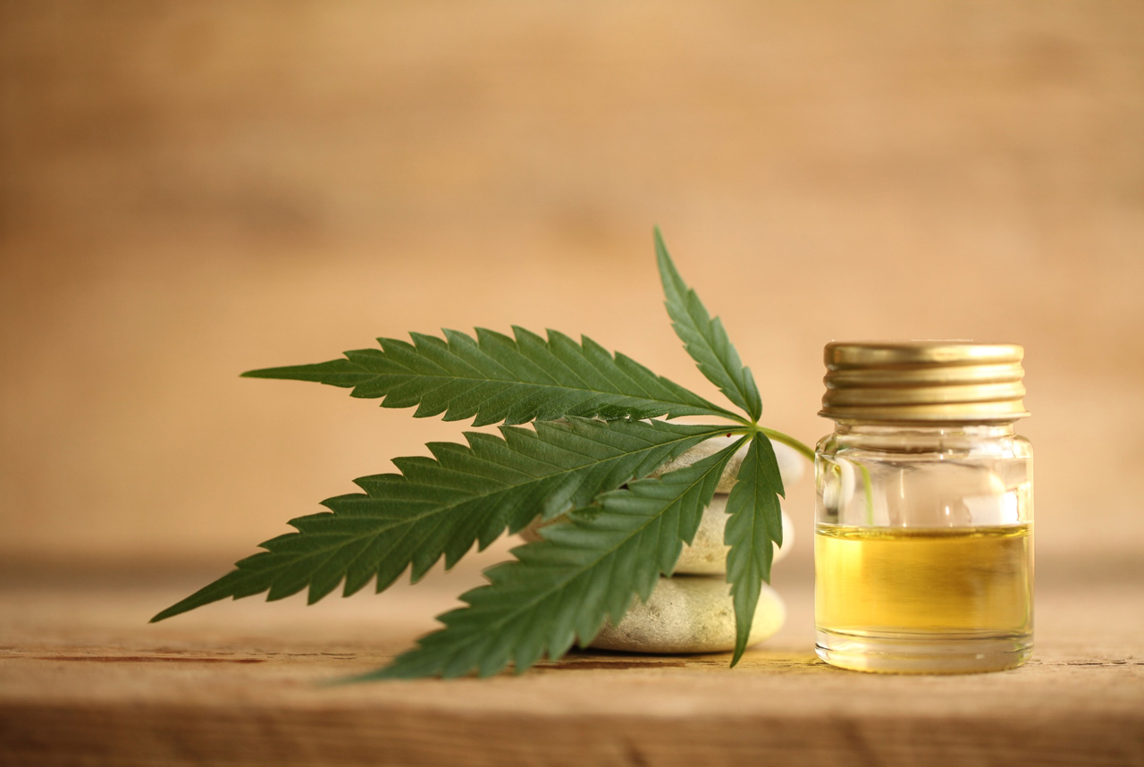 Premium hemp CBD oil with cannabis leaves showcased for cbd store tulsa products, natural wellness, quality extracts.