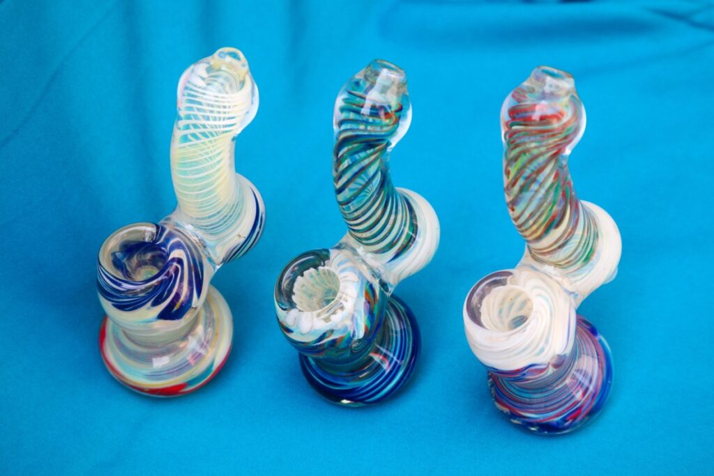 Handcrafted glass pipes Tulsa bubblers with intricate colorful swirl patterns and upright water chamber designs.