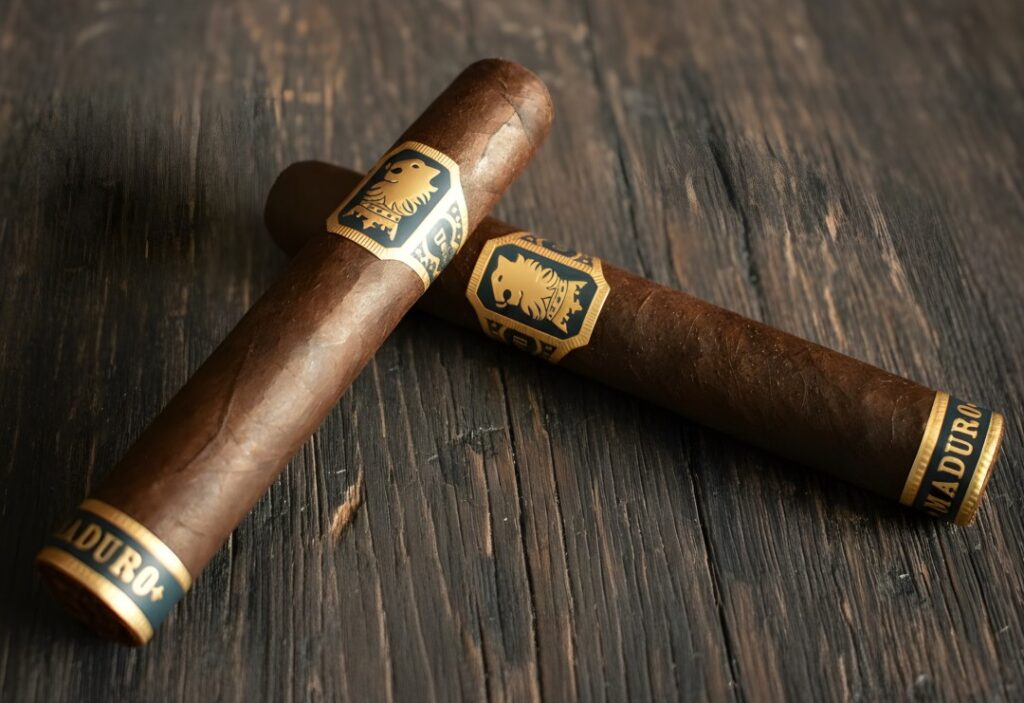 Two premium Maduro cigars on a wood table, perfect for any luxury cigar shop Tulsa enthusiast to enjoy daily.