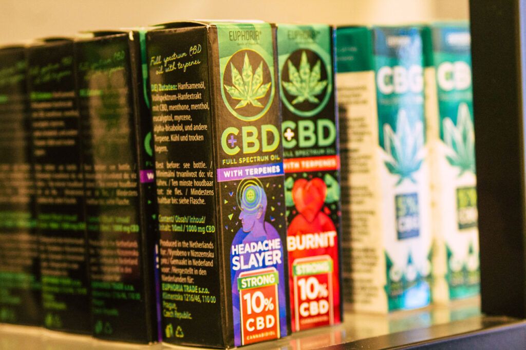 A detailed retail display of unique Euphoria brand full spectrum CBD oils for headache relief at a specialized cbd shop Tulsa.