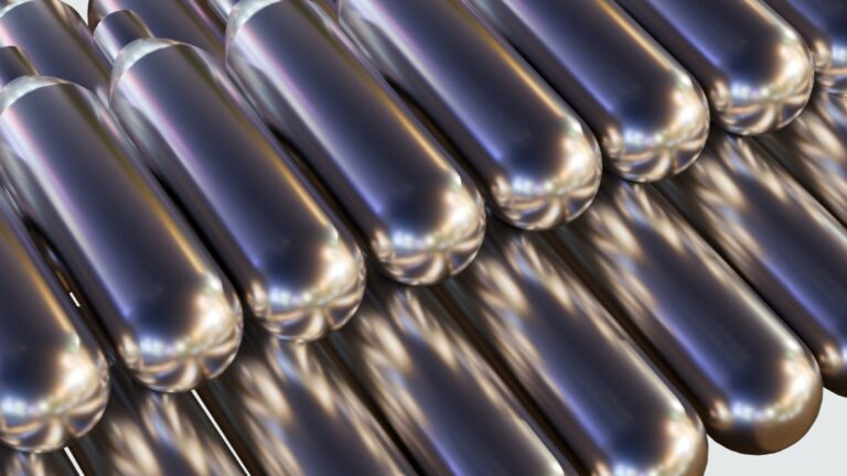 Close up of chrome metallic nitrous oxide Tulsa cylinders reflecting light in a professional industrial warehouse.