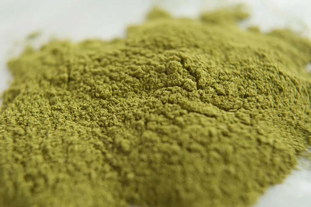 Close up of a textured pile of organic herbal powder available at a leading kratom retail Tulsa store location.