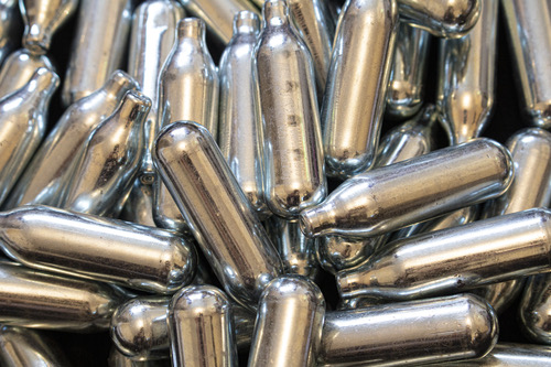 A dense pile of silver nitrous oxide chargers Tulsa available for professional catering and food grade applications.